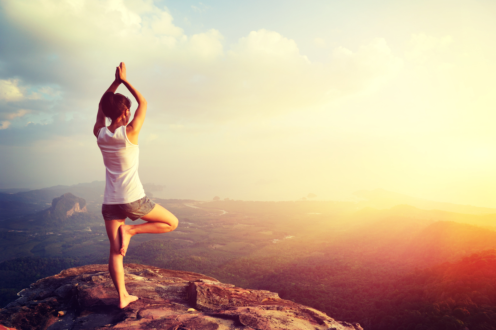 yoga woman meditation on mountain peak